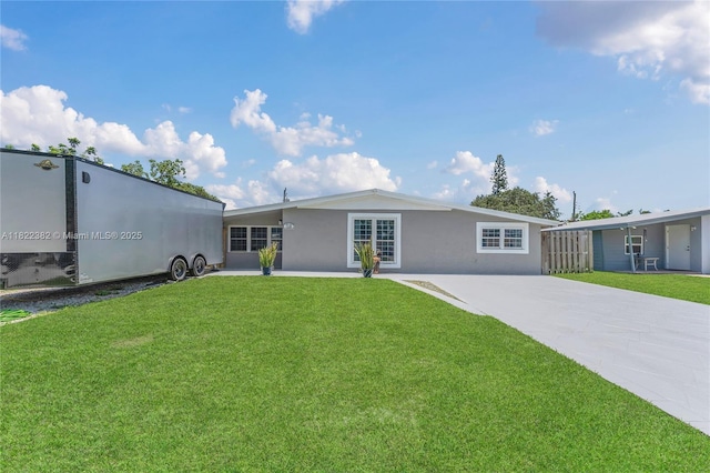 7540 Simms St, Hollywood, FL 33024 - view of front of property featuring stucco siding, a front yard, and driveway