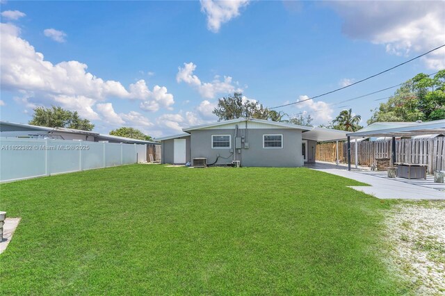 7540 Simms St, Hollywood, FL 33024 - back of house featuring a fenced backyard, stucco siding, and an attached carport