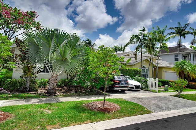 3457 NE 2nd St, Homestead, FL 33033 - obstructed view of property with decorative driveway, stucco siding, and a front lawn