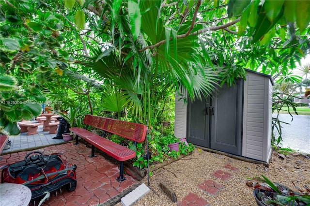 3457 NE 2nd St, Homestead, FL 33033 - view of exterior entry featuring a patio and a water view