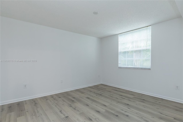 1919 Van Buren St Unit 205A, Hollywood, FL 33020 - unfurnished room with light wood-style flooring and a textured ceiling