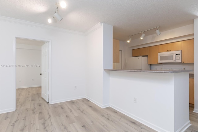 1919 Van Buren St Unit 205A, Hollywood, FL 33020 - kitchen with white appliances, track lighting, a textured ceiling, light wood-style flooring, and crown molding