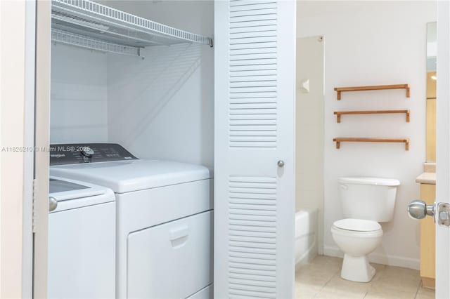 1919 Van Buren St Unit 205A, Hollywood, FL 33020 - washroom featuring separate washer and dryer and light tile patterned flooring