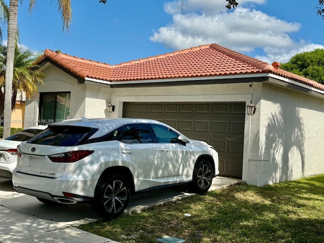 17673 SW 19th St, Miramar, FL 33029 - view of property exterior with stucco siding, an attached garage, a tile roof, and concrete driveway