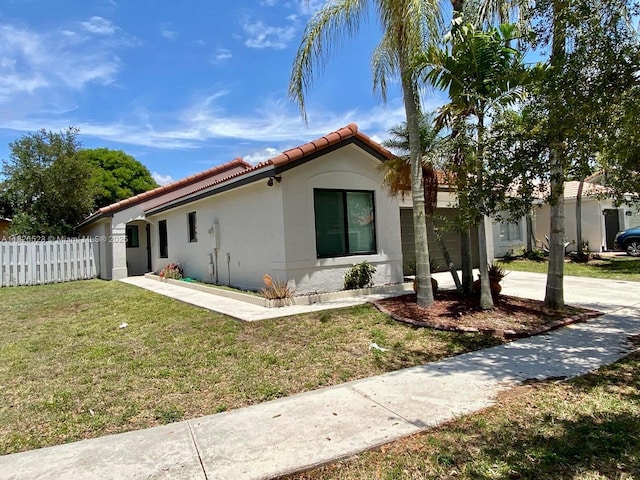 17673 SW 19th St, Miramar, FL 33029 - view of property exterior with a garage, a tiled roof, stucco siding, and concrete driveway