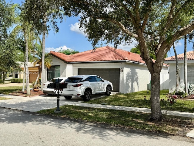 17673 SW 19th St, Miramar, FL 33029 - view of home's exterior with a tile roof, stucco siding, a garage, and concrete driveway