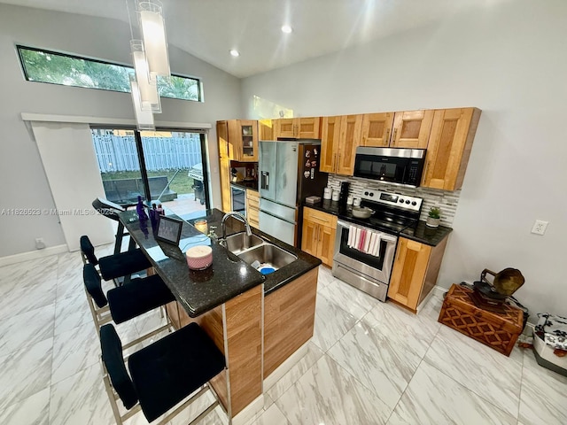 17673 SW 19th St, Miramar, FL 33029 - kitchen featuring stainless steel appliances, high vaulted ceiling, tasteful backsplash, light marble finish flooring, and a breakfast bar area