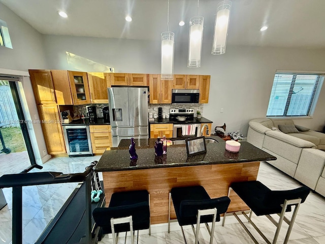 17673 SW 19th St, Miramar, FL 33029 - kitchen with stainless steel appliances, wine cooler, light marble finish floors, decorative backsplash, and a high ceiling