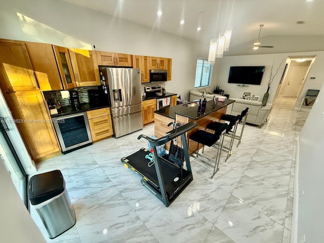 17673 SW 19th St, Miramar, FL 33029 - kitchen with stainless steel appliances, beverage cooler, light marble finish floors, lofted ceiling, and ceiling fan