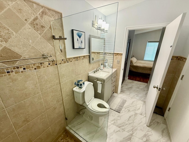 17673 SW 19th St, Miramar, FL 33029 - bathroom with tile walls, ensuite bath, vanity, marble finish floors, and a wainscoted wall