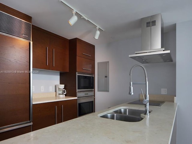 495 Brickell Ave Unit 4205, Miami, FL 33131 - kitchen with built in appliances, wall chimney exhaust hood, and rail lighting