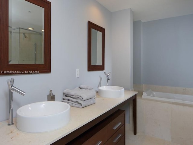 495 Brickell Ave Unit 4205, Miami, FL 33131 - bathroom featuring a garden tub, a stall shower, and double vanity