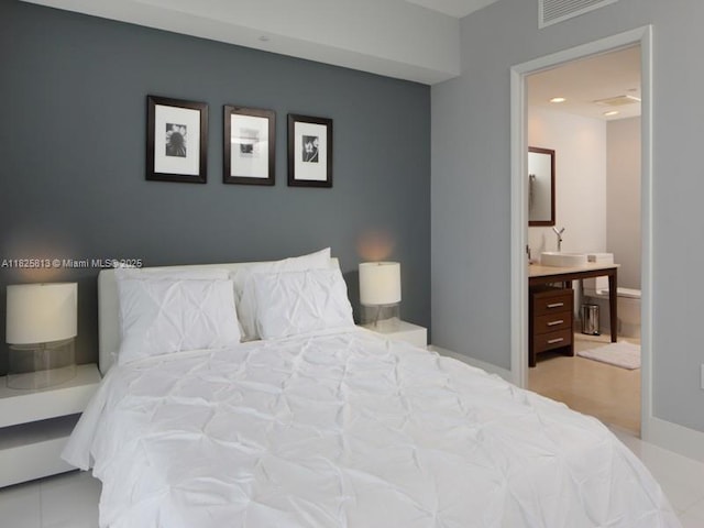 495 Brickell Ave Unit 4205, Miami, FL 33131 - bedroom featuring ensuite bath and baseboards