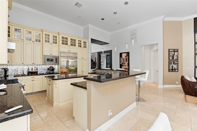 17866 Lake Azure Way, Boca Raton, FL 33496 - kitchen with cream cabinets, built in appliances, a kitchen island, tasteful backsplash, and crown molding