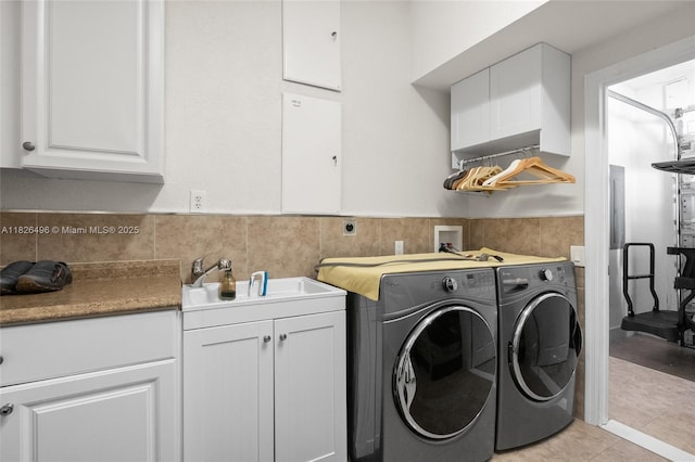 17866 Lake Azure Way, Boca Raton, FL 33496 - washroom with washing machine and dryer, cabinet space, wainscoting, and light tile patterned floors