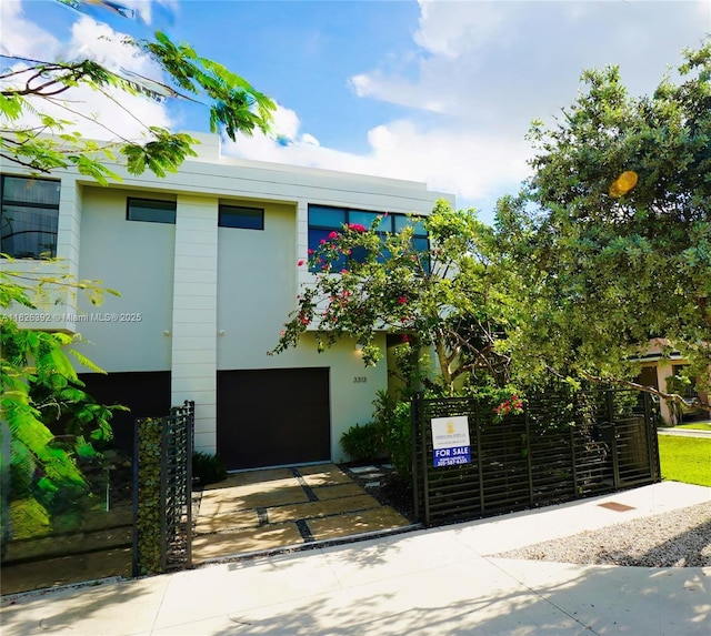 3313 Percival Ave Unit 3313, Miami, FL 33133 - view of front of property with a garage, stucco siding, and concrete driveway
