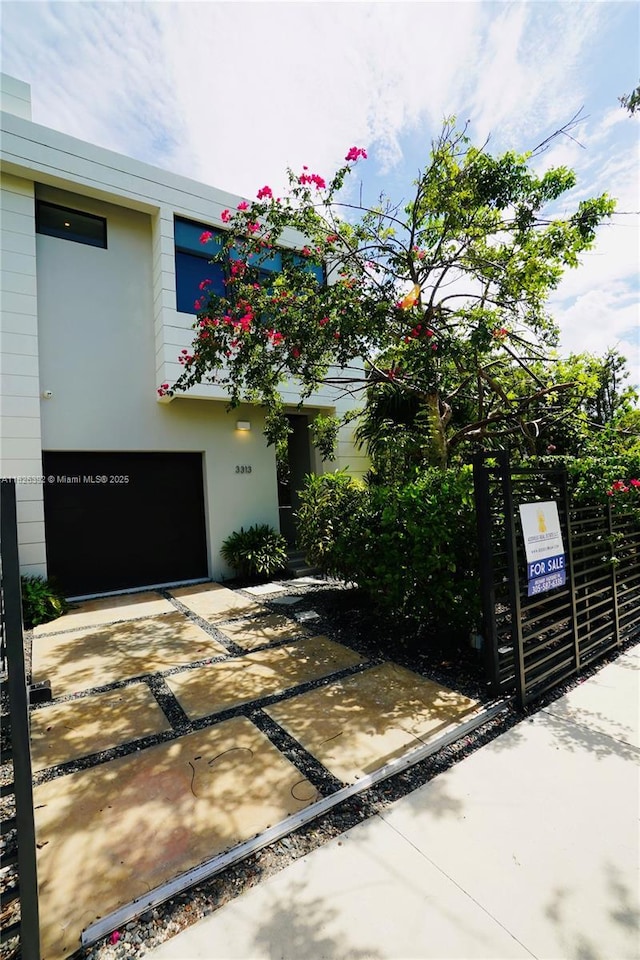 3313 Percival Ave Unit 3313, Miami, FL 33133 - view of front facade featuring concrete driveway, a garage, and stucco siding