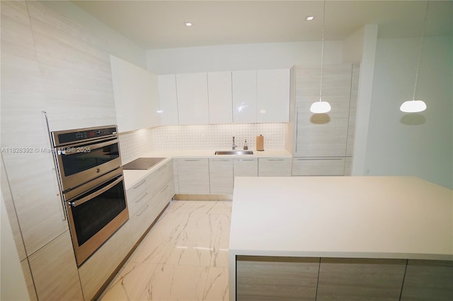 3313 Percival Ave Unit 3313, Miami, FL 33133 - kitchen featuring modern cabinets, black electric cooktop, double oven, white cabinetry, and light countertops