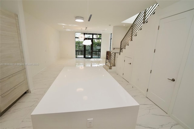 3313 Percival Ave Unit 3313, Miami, FL 33133 - hall with light marble finish floors, stairs, and expansive windows