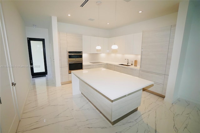 3313 Percival Ave Unit 3313, Miami, FL 33133 - kitchen with modern cabinets, double oven, light marble finish floors, a center island, and light countertops