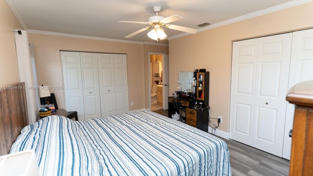 8443 Garden Gate Pl, Boca Raton, FL 33433 - bedroom with wood finished floors, ornamental molding, multiple closets, and a ceiling fan