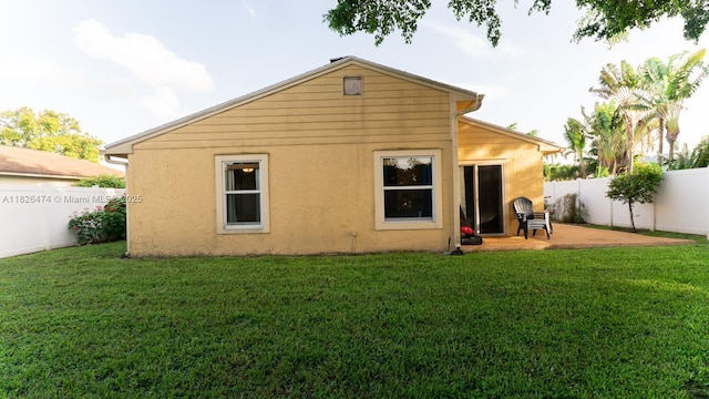 8443 Garden Gate Pl, Boca Raton, FL 33433 - back of property featuring a fenced backyard, stucco siding, and a patio area