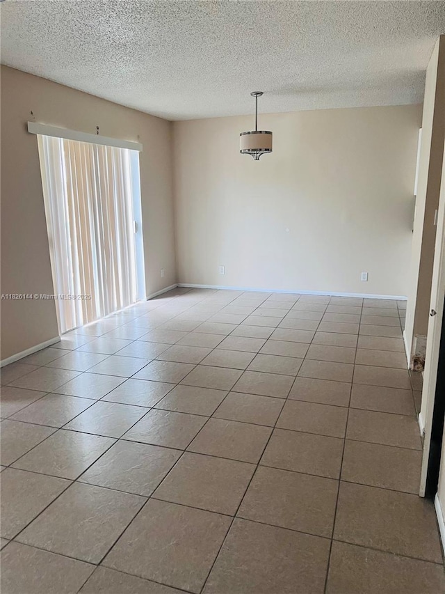 8917 NW 28th Dr Unit C-51, Coral Springs, FL 33065 - tiled empty room featuring a textured ceiling and baseboards