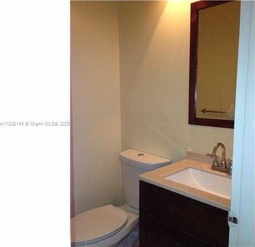 8917 NW 28th Dr Unit C-51, Coral Springs, FL 33065 - half bathroom featuring vanity and toilet