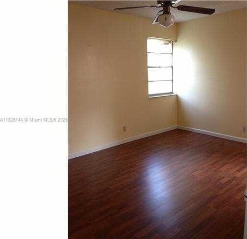 8917 NW 28th Dr Unit C-51, Coral Springs, FL 33065 - unfurnished room with a ceiling fan and wood finished floors