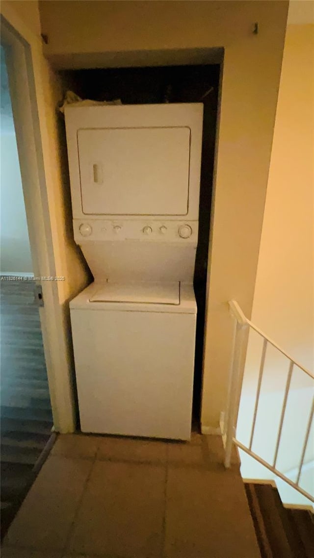 8917 NW 28th Dr Unit C-51, Coral Springs, FL 33065 - washroom with stacked washer / dryer and tile patterned flooring