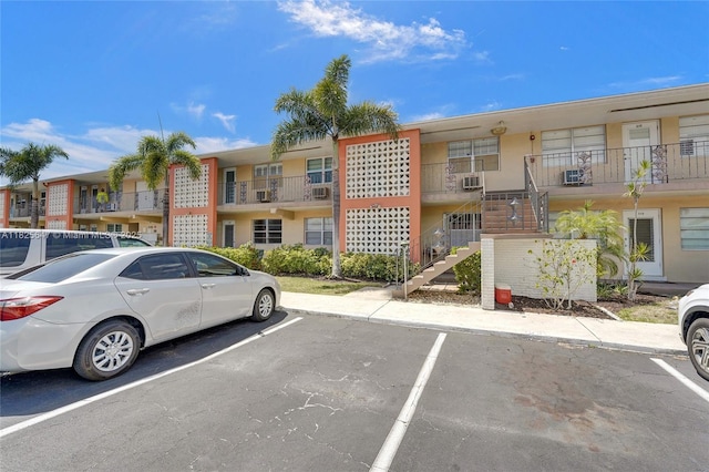 2106 NE 56th Ct Unit 108, Fort Lauderdale, FL 33308 - view of property with stairs, uncovered parking, and cooling unit