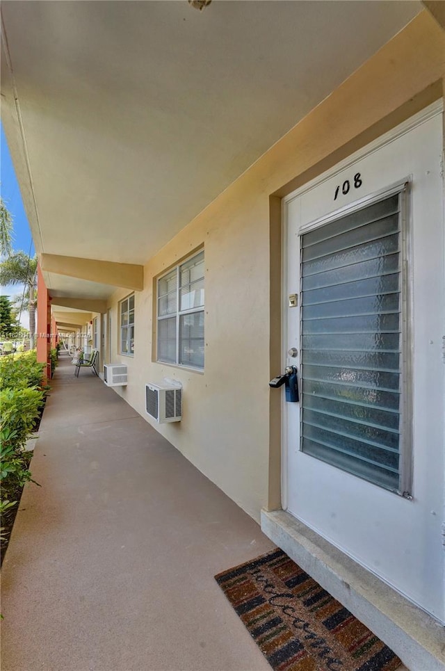 2106 NE 56th Ct Unit 108, Fort Lauderdale, FL 33308 - entrance to property featuring stucco siding and a wall mounted air conditioner