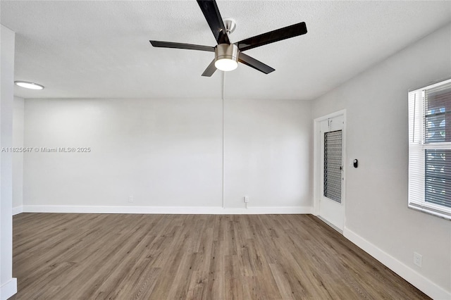 2106 NE 56th Ct Unit 108, Fort Lauderdale, FL 33308 - empty room featuring wood finished floors, a ceiling fan, and a textured ceiling