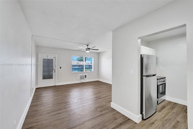 2106 NE 56th Ct Unit 108, Fort Lauderdale, FL 33308 - unfurnished living room with a ceiling fan, an AC wall unit, and light wood finished floors