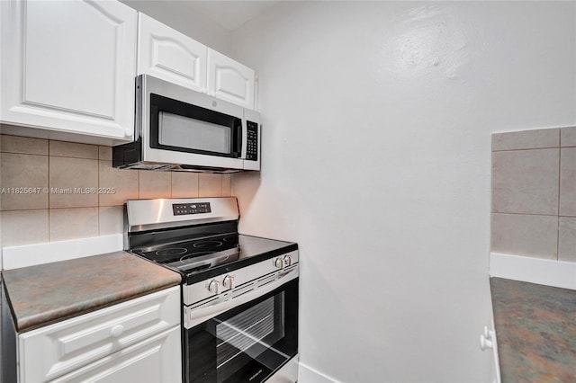 2106 NE 56th Ct Unit 108, Fort Lauderdale, FL 33308 - kitchen featuring appliances with stainless steel finishes, backsplash, and white cabinetry