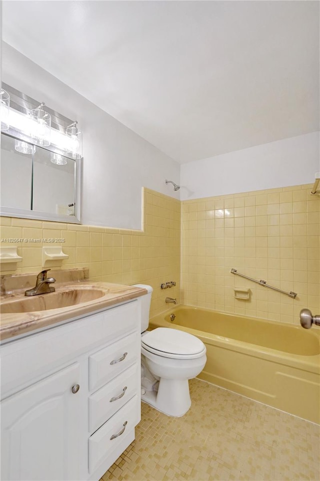 2106 NE 56th Ct Unit 108, Fort Lauderdale, FL 33308 - bathroom with tile walls, vanity, and washtub / shower combination