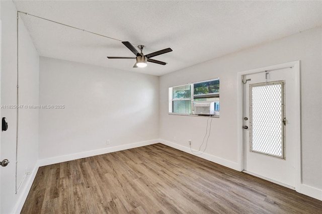 2106 NE 56th Ct Unit 108, Fort Lauderdale, FL 33308 - spare room with wood finished floors, a ceiling fan, and cooling unit