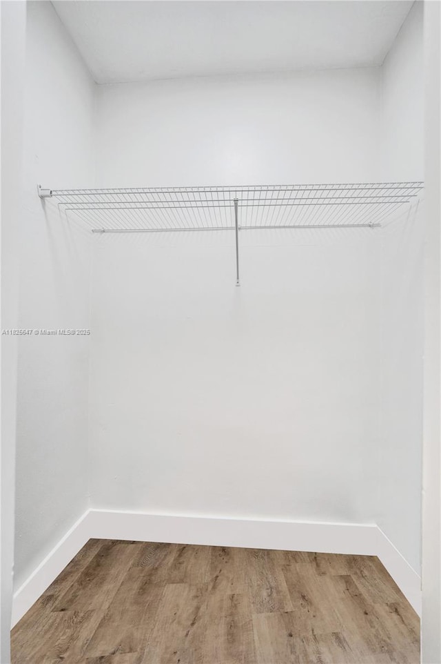 2106 NE 56th Ct Unit 108, Fort Lauderdale, FL 33308 - walk in closet featuring wood finished floors