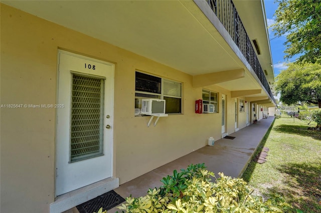 2106 NE 56th Ct Unit 108, Fort Lauderdale, FL 33308 - property entrance with stucco siding and cooling unit