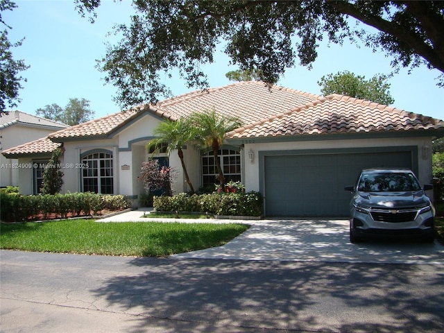 3502 Dunes Vista Dr, Pompano Beach, FL 33069 - mediterranean / spanish-style house featuring a tiled roof, stucco siding, driveway, and a garage