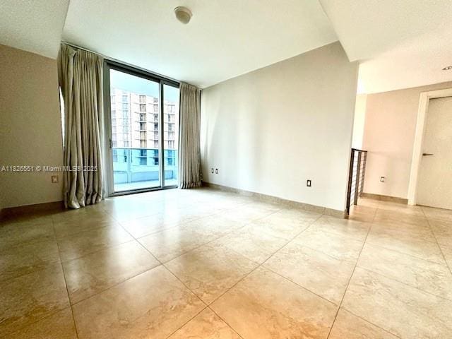 200 Biscayne Boulevard Way Unit 701, Miami, FL 33131 - spare room featuring light tile patterned floors and expansive windows