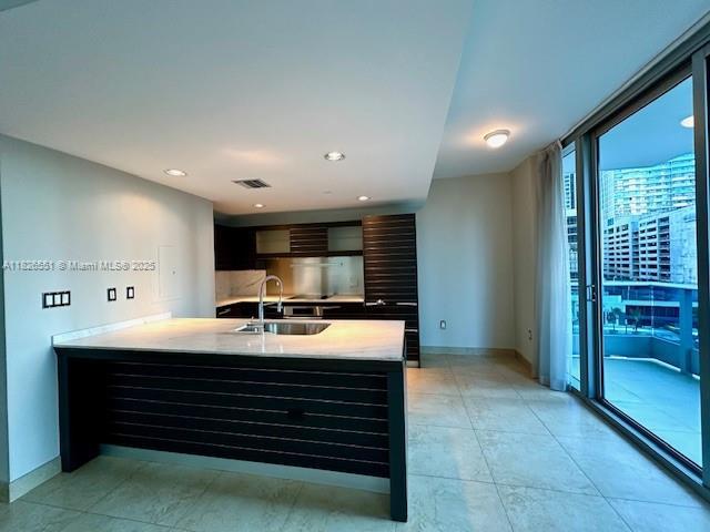 200 Biscayne Boulevard Way Unit 701, Miami, FL 33131 - kitchen featuring modern cabinets, light countertops, recessed lighting, and a wall of windows