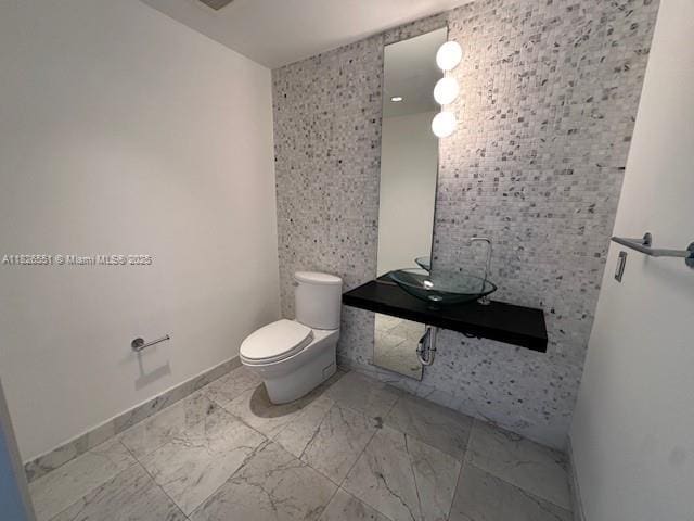 200 Biscayne Boulevard Way Unit 701, Miami, FL 33131 - half bathroom with toilet and marble finish floors