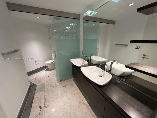 200 Biscayne Boulevard Way Unit 701, Miami, FL 33131 - full bath featuring marble finish floors, a walk in shower, double vanity, and recessed lighting