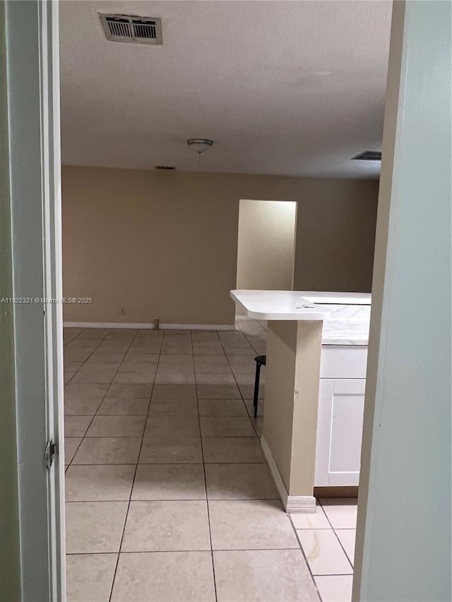 15 Crossings Cir Unit F, Boynton Beach, FL 33435 - hall featuring light tile patterned floors and a textured ceiling