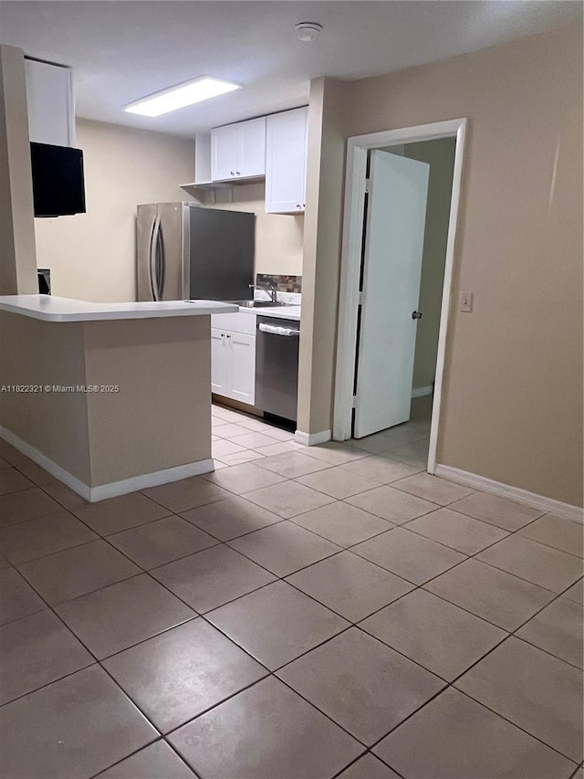 15 Crossings Cir Unit F, Boynton Beach, FL 33435 - kitchen with stainless steel appliances, light tile patterned floors, white cabinets, and light countertops