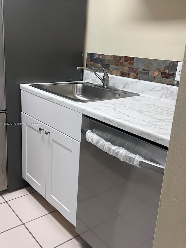 15 Crossings Cir Unit F, Boynton Beach, FL 33435 - kitchen featuring light tile patterned flooring, white cabinetry, stainless steel dishwasher, and light countertops