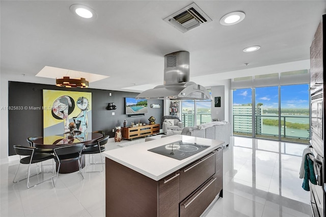 7930 E Dr Unit 1806, North Bay Village, FL 33141 - kitchen with black electric stovetop, island exhaust hood, light tile patterned floors, light countertops, and recessed lighting