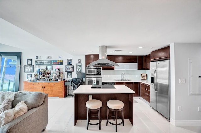 7930 E Dr Unit 1806, North Bay Village, FL 33141 - kitchen with appliances with stainless steel finishes, island exhaust hood, a kitchen island, light countertops, and light tile patterned floors