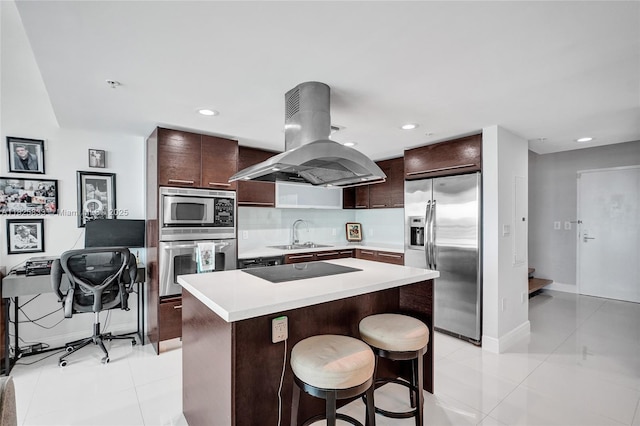 7930 E Dr Unit 1806, North Bay Village, FL 33141 - kitchen featuring stainless steel appliances, island exhaust hood, light countertops, a kitchen island, and a kitchen breakfast bar